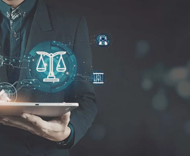 A person in a suit using a stylus on a tablet that displays glowing holographic legal icons, including the scales of justice and a gavel.