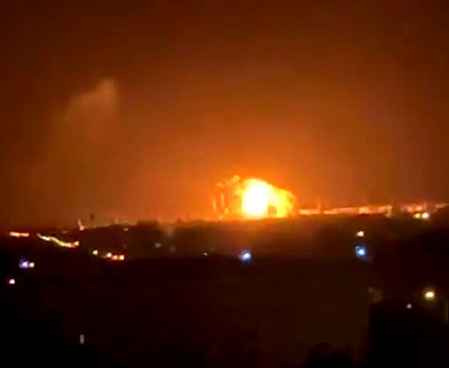 Nighttime Explosion Over a Darkened Cityscape