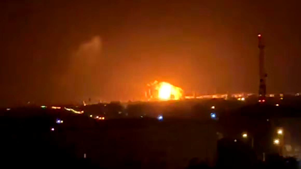 Nighttime Explosion Over a Darkened Cityscape